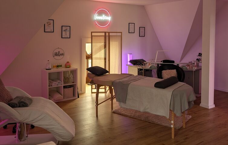 Das Studio von Vannilicious mit Behandlungsliege und Neon-Schriftzug
